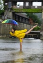 Rainy day. Funny excited woman in raincoat hold umbrella with rainy water drops. Girl in rain with umbrella in rainy Royalty Free Stock Photo