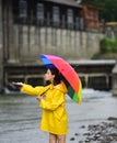 Rainy day. Funny woman hold umbrella with rainy water drops. Girl under falling water drops in rainy season. Woman with Royalty Free Stock Photo