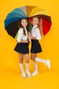 Rainy day. Happy childhood. School time. Rainbow umbrella. Colorful life. Schoolgirls happy big umbrella. Fall weather