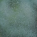 Rainy day, raindrops on wet window glass, vertical bright abstract rain water background pattern detail, macro closeup, detailed