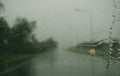 Rainy day on the road, Raindrops on car mirror with side wing mirror Royalty Free Stock Photo