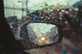 Rainy day on the road, Raindrops on car mirror with side wing mirror Royalty Free Stock Photo