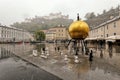 Rainy day on Salzburg square with golden globe