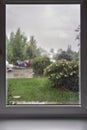 Rainy day view from the window, raindrops on glass, blurred cloudy rainy sky background Royalty Free Stock Photo