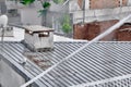 Rainy day and wet roof of house made of metal panels. Royalty Free Stock Photo