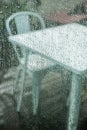 Rainy days on a terrace with metal furniture Royalty Free Stock Photo