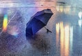 Rainy evening blurred light wet asphalt and umbrella on street road weather forecast season background Royalty Free Stock Photo