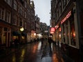 Rainy evening night in illuminated Chinatown Zeedijk street central Amsterdam Holland Netherlands Royalty Free Stock Photo