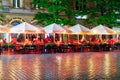 Rainy evening with people sitting at terraces market square Krakow Royalty Free Stock Photo