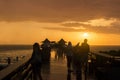 Rainy evening sunset sky on the sea of Mexican Gulf, silhouettes of tourists people on beach pier