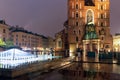 Rainy evening market square Krakow with church and fountain, Poland Royalty Free Stock Photo