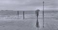 Rainy and fogy day in Venice with lonely woman with umbrella and moody seascape on backround