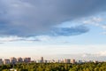 Rainy gray cloud in blue evening sky over city Royalty Free Stock Photo