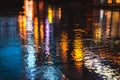 Rainy night in a big city, reflections of lights on the wet road surface. Royalty Free Stock Photo