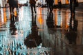 Rainy night in a big city, reflections of lights on the wet road surface.