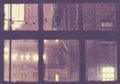 Rainy night in New York City through an old window, retro color toning applied, USA Royalty Free Stock Photo