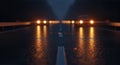 Rainy Night Road with Distant Glowing Lights and Reflections Royalty Free Stock Photo