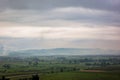 Rainy panorama over green fields