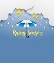 Rainy season. design with raining drops, umbrella and clouds on blue background.