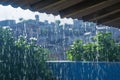 Rainy season drama Heavy raindrops cascade on a rooftop Royalty Free Stock Photo
