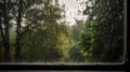 Rainy sunny day, beautiful landscape photo, view through the windows on which there are drops of rain Royalty Free Stock Photo