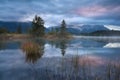 Rainy sunrise over Barmsee lake