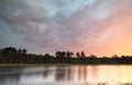 Rainy sunrise on wild forest lake