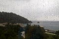 Rainy view on the beach through the window Royalty Free Stock Photo