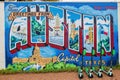 Rainy view of the Greetings From Austin Mural