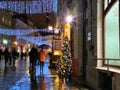 Rainy weather evening Tallinn romantic senior couple ,people walking on street ,blurred light , Estonia ,travelling   Christmas Royalty Free Stock Photo