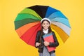 rainy weather forecast. back to school. vivid rain protection. happy girl in glasses hold notebook Royalty Free Stock Photo