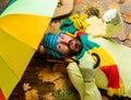 Rainy weather forecast concept. Man bearded lay on wooden background with leaves top view. Fall season attributes Royalty Free Stock Photo