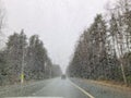 Rainy weather on highway, rain drops on the windshield. Abstract cars, blurred backdrop.Dangerous vehicle driving in the