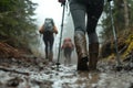 In rainy weather, hikers trek through muddy paths Royalty Free Stock Photo