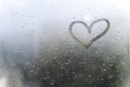 Rainy weather, the inscription heart on the sweaty glass