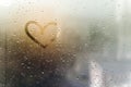 Rainy weather, the inscription heart on the sweaty glass