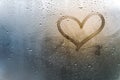 Rainy weather, the inscription heart on the sweaty glass