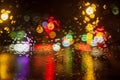 Rainy weather, night city, raindrops through the glass, abstract background from the light of cars and traffic lights, defocus, Royalty Free Stock Photo