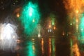 Rainy weather  night city  raindrops through the glass  abstract background from the light of cars and traffic lights  defocus Royalty Free Stock Photo