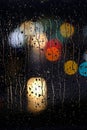 Rainy Wet Window at Night with Water Drops and City Lights Royalty Free Stock Photo