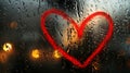 A rainy window with a red heart, creating a romantic, blurred background Royalty Free Stock Photo