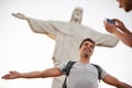 Raise your arms a little higher...a happy young couple taking photos at the Christ the Redeemer statue.