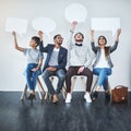 Raise your voice. Full length shot of a diverse group of businesspeople holding up speech bubbles while they wait in Royalty Free Stock Photo