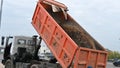 Raised bucket of a truck, unloading sand