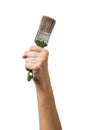 A raised female hand holds a brush for painting various surfaces. Worker with tool isolated Royalty Free Stock Photo