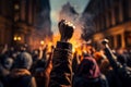 Raised fist of afro american man in large angry protest riot crowd of people