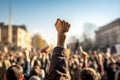 A raised fist of a protestor. large group of protesters. Generative AI