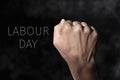 Raised fist and text labour day