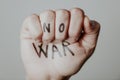 Raised fist with the text no war written in it