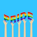 Raised hands holding together PRIDE word on blue background